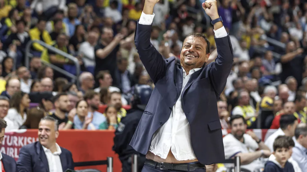 Panathinaikos Athens head coach Ergin Ataman cheers after the victory in the final round of the basketball Euroleague semifinal between Panathinaikos Athens and Fenerbahce Istanbul, at the Uber Arena in Berlin, Friday May 24, 2024. (Andreas Gora/dpa via AP)