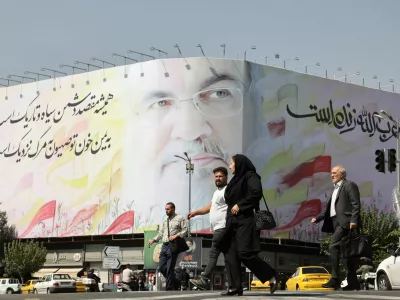 People walk past a billboard with a picture of the late Lebanon's Hezbollah leader Hassan Nasrallah, in a street in Tehran, Iran October 2, 2024. Majid Asgaripour/WANA (West Asia News Agency) via REUTERS ATTENTION EDITORS - THIS IMAGE HAS BEEN SUPPLIED BY A THIRD PARTY.