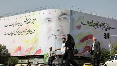 People walk past a billboard with a picture of the late Lebanon's Hezbollah leader Hassan Nasrallah, in a street in Tehran, Iran October 2, 2024. Majid Asgaripour/WANA (West Asia News Agency) via REUTERS ATTENTION EDITORS - THIS IMAGE HAS BEEN SUPPLIED BY A THIRD PARTY.