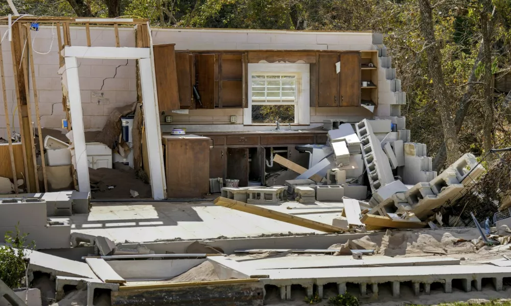 Damaged to one of the White family's homes that was destroyed by Hurricane Helene is seen, Tuesday, Oct. 1, 2024 in Morganton, N.C. The adjacent Catawba River flooded due to torrential rains destroying the seven of family's nine homes on the property. (AP Photo/Kathy Kmonicek)