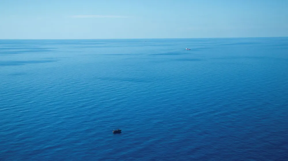 The boat in distress with about 400 people on board is pictured with Merchant vessels Pericles and FMT Urla in the background, in Central Mediterranean in this handout obtained by Reuters on April 10, 2023. Giacomo Zorzi/ Sea-Watch/Handout via REUTERS  THIS IMAGE HAS BEEN SUPPLIED BY A THIRD PARTY. NO RESALES. NO ARCHIVES.