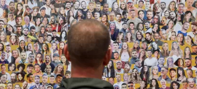 A soldier looks at the pictures of the Nova festival victims, who were killed and kidnapped during the October 7 attack by Hamas gunmen from Gaza, on Israel's Memorial Day, when the country commemorates fallen soldiers of Israel's wars and Israeli victims of hostile attacks, in Reim, southern Israel May 13, 2024. REUTERS/Amir Cohen