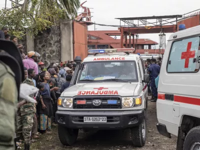 An ambulance carries victims away from the port of Goma, Democratic Republic of Congo, after a ferry carrying hundreds capsized on arrival Thursday, Oct. 3, 2024. (AP Photo/Moses Sawasawa)