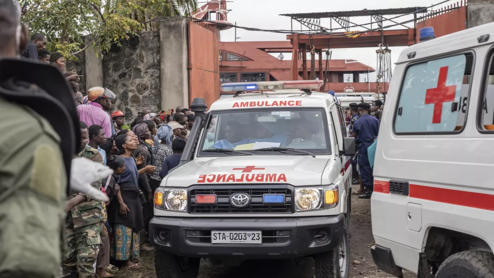 An ambulance carries victims away from the port of Goma, Democratic Republic of Congo, after a ferry carrying hundreds capsized on arrival Thursday, Oct. 3, 2024. (AP Photo/Moses Sawasawa)