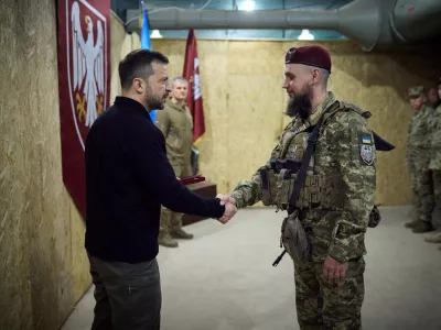 Ukraine's President Volodymyr Zelenskiy shakes hands with a service member during his visit to a position of Ukrainian troops, in the course of Russia-Ukraine conflict, in Sumy region, Ukraine October 4, 2024. Ukrainian Presidential Press Service/Handout via REUTERS ATTENTION EDITORS - THIS IMAGE HAS BEEN SUPPLIED BY A THIRD PARTY.