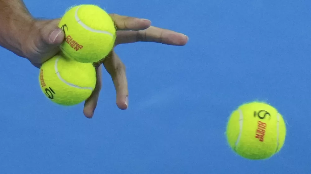 Carlos Alcaraz of Spain chooses balls during the men's singles finals match against Jannik Sinner of Italy at the China Open tennis tournament, National Tennis Center in Beijing, Wednesday, Oct. 2, 2024. (AP Photo/Andy Wong)