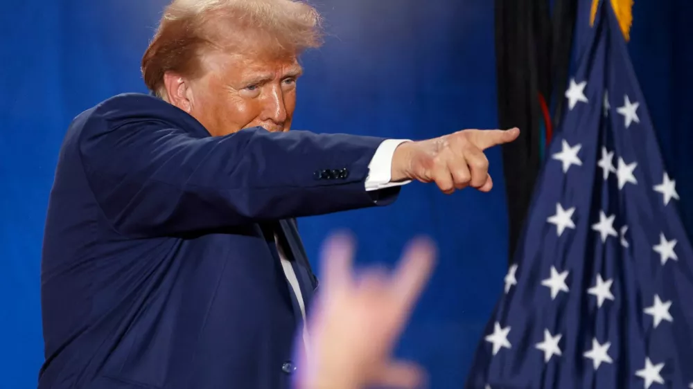 Republican presidential nominee and former U.S. President Donald Trump points to a supporter at the end of a town hall as he campaigns in Fayetteville, North Carolina, U.S. October 4, 2024. REUTERS/Jonathan Drake