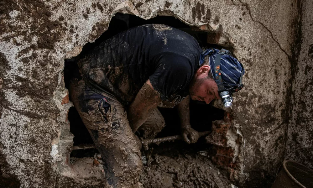 A man searches for victims following a landslide in the flooded village of Donja Jablanica, Bosnia and Herzegovina, October 5, 2024. REUTERS/Marko Djurica