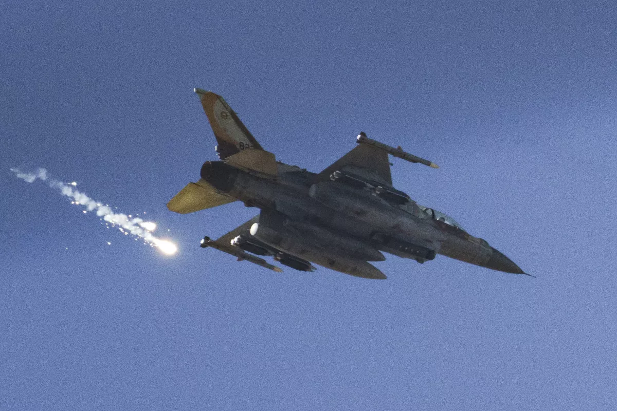 FILE - An Israeli fighter jet releases flares as it flies over the Gaza Strip, as seen from southern Israel, Dec. 9, 2023. (AP Photo/Leo Correa, File)