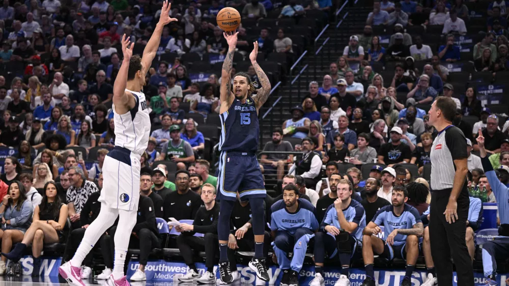 Oct 7, 2024; Dallas, Texas, USA; Memphis Grizzlies forward Brandon Clarke (15) makes a shot over Dallas Mavericks center Dwight Powell (7) during the second half at the American Airlines Center. Mandatory Credit: Jerome Miron-Imagn Images