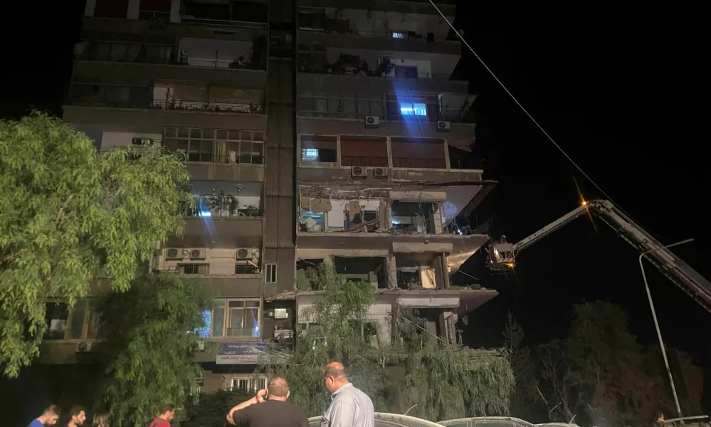 Rescuers work at the site of an Israeli airstrike that targeted a residential building in the Mezzah suburb west of the Syrian capital Damascus, Syria's state news agency reported, Syria October 8, 2024. REUTERS/Firas Makdesi