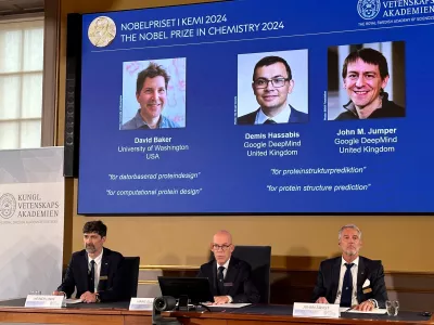 09 October 2024, Sweden, Stockholm: Images of (L-R) David Baker, Demis Hassabis, and John M. Jumper are shown on the screen during the press conference announcing the 2024 Nobel Prize in Chemistry. Half of this year's Nobel Prize in Chemistry goes to David Baker (USA), the other half to Demis Hassabis and John Jumper, who both work in the UK. Baker receives the prize for computer-aided protein design, Hassabis and Jumper for the prediction of the complex structures of proteins. This was announced by the Royal Swedish Academy of Sciences in Stockholm. Photo: Steffen Trumpf/dpa