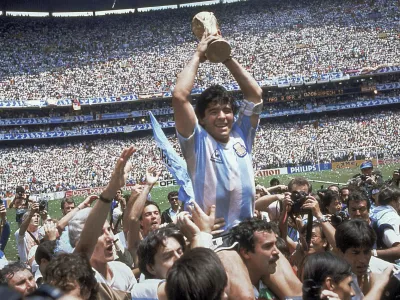 ﻿FILE - In this June 29, 1986, file photo, Diego Maradona holds up his team's trophy after Argentina's 3-2 victory over West Germany at the World Cup final soccer match at Azteca Stadium in Mexico City. The Argentine soccer great who was among the best players ever and who led his country to the 1986 World Cup title died from a heart attack on Wednesday, Nov. 25, 2020, at his home in Buenos Aires. He was 60. (AP Photo/Carlo Fumagalli, File)