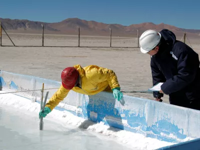 FILE PHOTO: Technicians from the Orocobre mining company work on an evaporation pond test in the salt flat at Olaroz, 4,000 meters (13,123 feet) above sea level and north of the Argentine province of San Salvador de Jujuy August 7, 2010. Orocobre's assets are now part of Arcadium Lithium, which global miner Rio Tinto wants to buy. Picture taken on August 7, 2010. REUTERS/Enrique Marcarian/File Photo