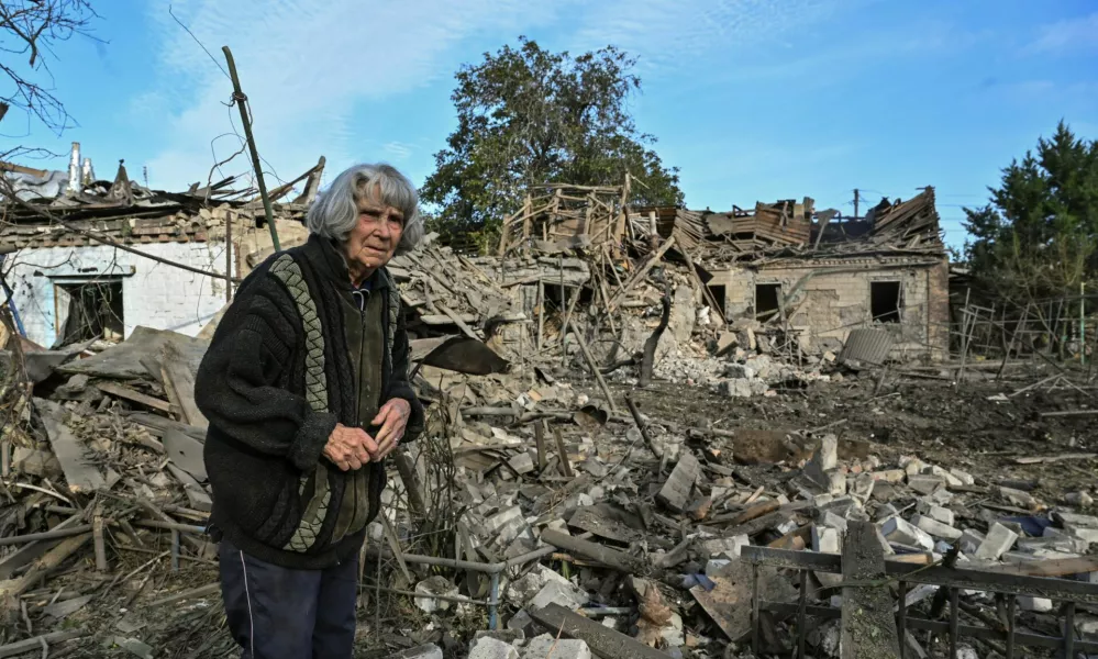 A woman stands in the backyard of her house destroyed by a Russian air strike, amid Russia's attack on Ukraine, in Zaporizhzhia, Ukraine October 10, 2024. REUTERS/Stringer