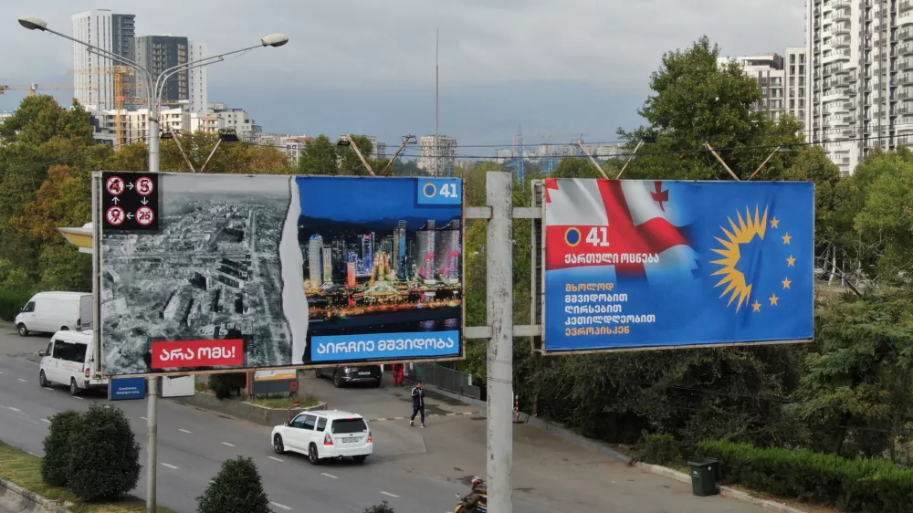 A drone view shows election billboards of the ruling Georgian Dream party, one of which depicts a devastated Ukrainian city contrasted against a peaceful Georgian one, in Tbilisi, Georgia September 27, 2024. REUTERS/Irakli Gedenidze