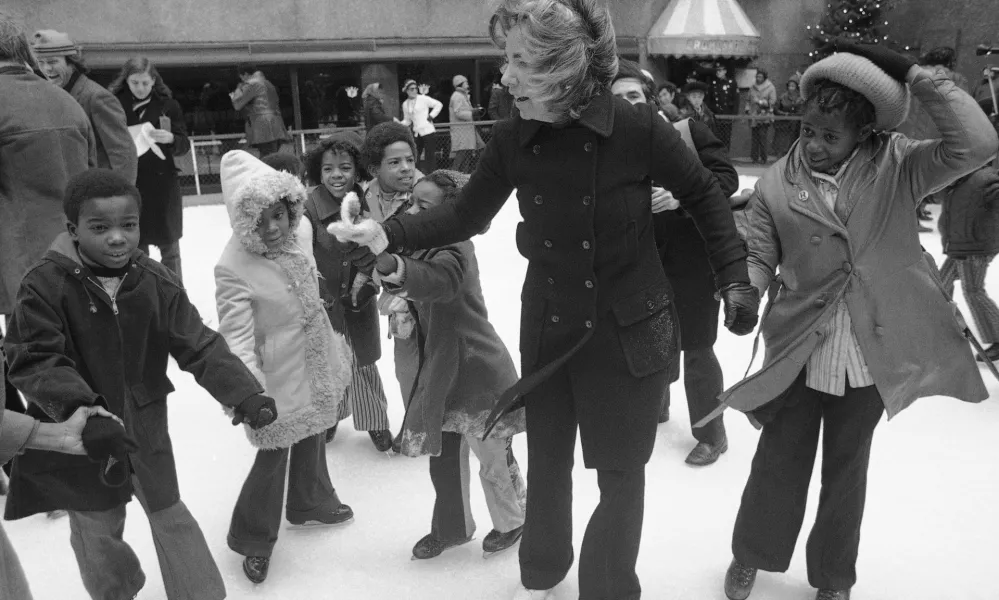 FILE - Ethel Kennedy, widow of Sen. Robert Kennedy, ice skates with youngsters from Bedford Stuyvesant, Brooklyn borough, at the eighth annual Kennedy skating party originated by the late senator at Rockefeller Center's skating rink on Dec. 16, 1972, in New York. (AP Photo, File) 