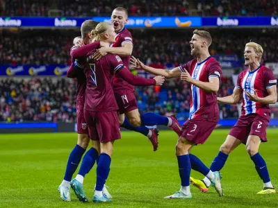 Norway's Erling Haaland, left, celebrates with teammates after scoring during the Nations League soccer match between Norway and Slovenia at Ullevaal Stadium, Thursday, Oct. 10, 2024, in Oslo, Norway. (Fredrik Varfjell/NTB Scanpix via AP)