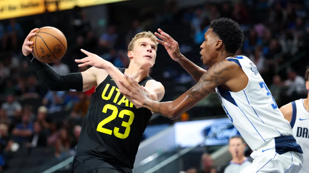 Oct 10, 2024; Dallas, Texas, USA; Utah Jazz forward Lauri Markkanen (23) drives to the basket as Dallas Mavericks center Jamarion Sharp (33) defends during the second half at American Airlines Center. Mandatory Credit: Kevin Jairaj-Imagn Images