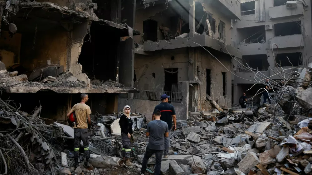 People inspect the site of an Israeli air strike, amid ongoing hostilities between Hezbollah and Israeli forces, in Beirut, Lebanon, October 11, 2024. REUTERS/Louisa Gouliamaki