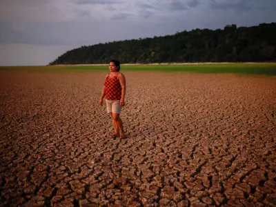 Alcineia de Sousa Ribeiro, 45, poses for a picture on the dry bed of a Tapajos river during the intense drought that hits the Amazon, at Prainha 1 community in Tapajos National Forest, Para state, Brazil October 10, 2024. REUTERS/Amanda Perobelli  TPX IMAGES OF THE DAY