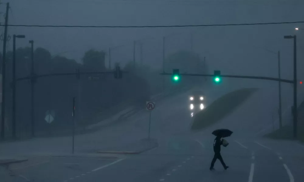 FILE PHOTO: A man walks down an avenue as Hurricane Milton approaches, in Orlando, Florida, U.S., October 9, 2024. REUTERS/Jose Luis Gonzalez/File Photo