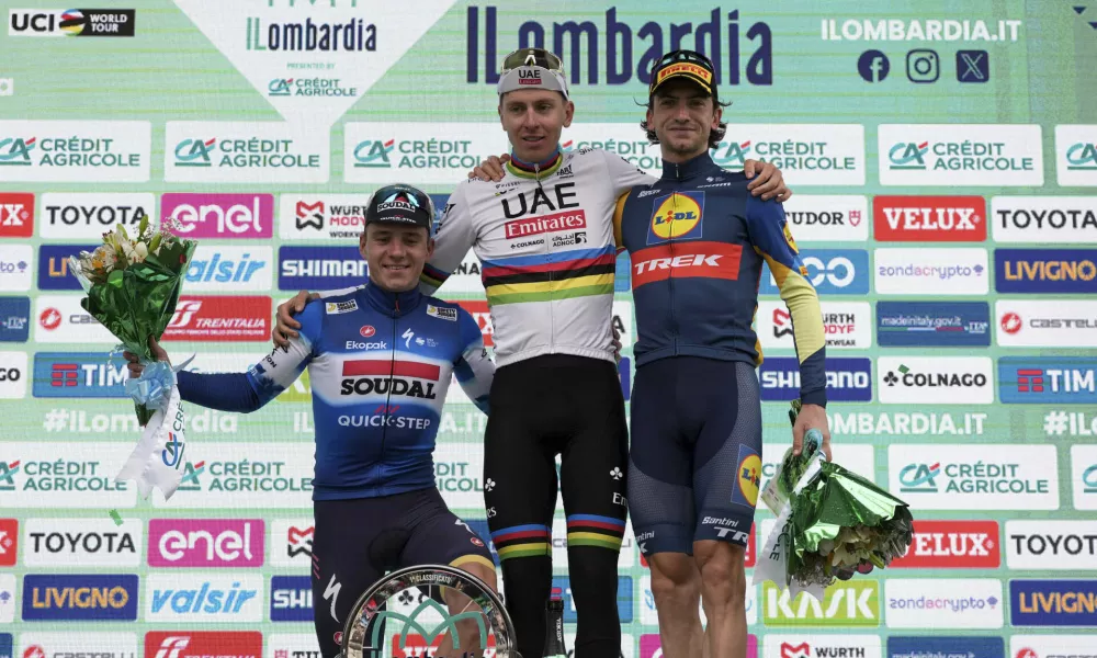 Reigning World Champion Slovenia's Tadej Pogacar, center, winner of Il Lombardia, Tour of Lombardy cycling race, poses on podium with second placed Belgium's Remco Evenepoel, left, and third placed Italy's Giulio Ciccone, in Como, Italy, Saturday, Oct. 12, 2024. (Gian Mattia D'Alberto/LaPresse via AP)