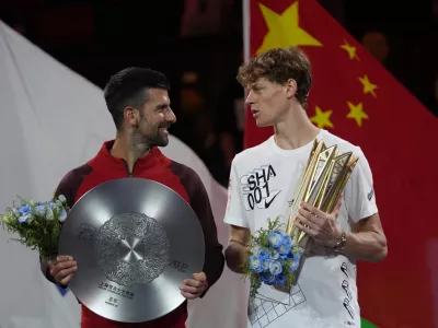 Jannik Sinner of Italy, right, chats with Novak Djokovic of Serbia during a trophy ceremony after their men's singles finals match for the Shanghai Masters tennis tournament at Qizhong Forest Sports City Tennis Center in Shanghai, China, Sunday, Oct. 13, 2024. (AP Photo/Andy Wong)