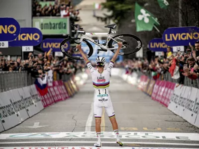 Reigning World Champion Slovenia's Tadej Pogacar celebrates winning Il Lombardia, Tour of Lombardy cycling race, in Como, Italy, Saturday, Oct. 12, 2024. (Marco Alpozzi/LaPresse via AP)