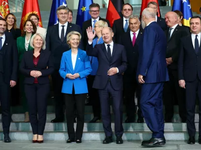 German Chancellor Olaf Scholz gestures during a family photo with European Commission President Ursula von der Leyen, Albania's Prime Minister Edi Rama, Hungarian Prime Minister Viktor Orban, Bulgaria's caretaker Prime Minister Dimitar Glavchev, Chairwoman of the Council of Ministers of Bosnia and Herzegovina Borjana Kristo, Kosovo's Prime Minister Albin Kurti, Croatian Prime Minister Andrej Plenkovic, Montenegro's Prime Minister Milojko Spajic, Slovenian President Natasa Pirc Musar, and other leaders from Western Balkan countries during the Berlin Process Summit, in Berlin, Germany, October 14, 2024. REUTERS/Lisi Niesner