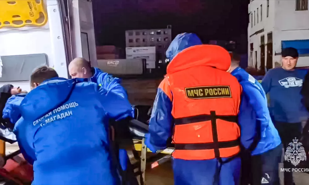 In this photo taken from video released by Russian Emergency Ministry Press Service on Tuesday, Oct. 15, 2024, Russian emergency workers transfer Mikhail Pichugin into an ambulance ashore after he was rescued by a fishing vessel following 67 days adrift in the Sea of Okhotsk near the village of Ust-Khairuzovo in Kamchatka region of Russian far east. (Russian Emergency Ministry Press Service via AP)