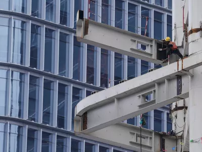 FILE PHOTO: A worker works on a building under construction in Beijing's Central Business District (CBD), China July 14, 2024. REUTERS/Tingshu Wang/File Photo