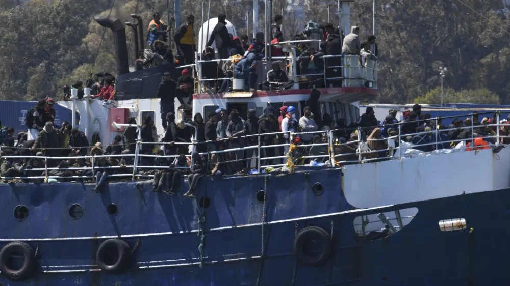 A ship carrying some 700 migrants enters the Sicilian port of Catania, Wednesday, April 12, 2023. Italy's right-wing government has declared a state of emergency to help it cope with a surge in migrants arriving on the country's southern shores. Premier Giorgia Meloni and her Cabinet on Tuesday, decided to impose the emergency status for six months. (AP Photo/Salvatore Cavalli)