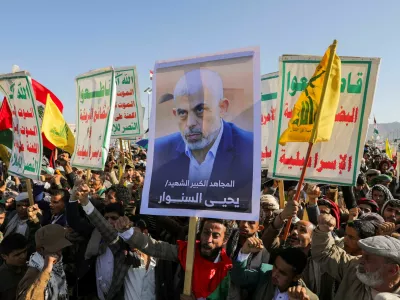 A person holds a sign showing the late Hamas leader Yahya Sinwar as protesters, mainly Houthi supporters, rally to show support to Lebanon's Hezbollah and Palestinians in the Gaza Strip, in Sanaa, Yemen October 18, 2024. REUTERS/Khaled Abdullah