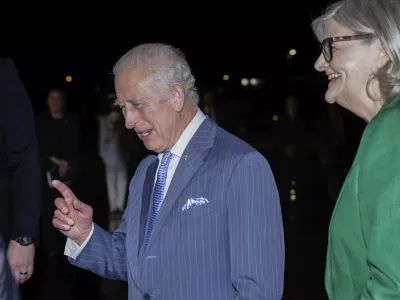 Britain's King Charles gestures as he talks with Ms Sam Mostyn, Governor-General of Australia on his arrival in Sydney for the start of a five-day tour to Australia, Friday, Oct. 18, 2024. (Brook Mitchell/Pool Photo via AP)