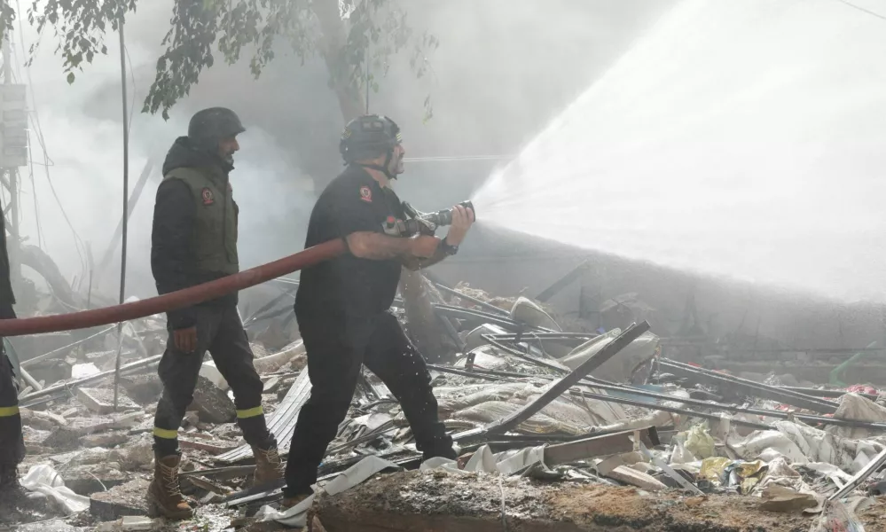 Civil defence members put out a fire at a damaged site, in the aftermath of Israeli strikes on Beirut's southern suburbs, Lebanon October 20, 2024. REUTERS/Ali Alloush