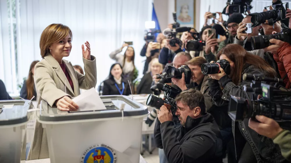 Moldova's President Maia Sandu prepares to cast her vote, in Chisinau, Moldova, Sunday, Oct. 20, 2024, during a presidential election and a referendum on whether to enshrine in the Constitution the country's path to European Union membership. (AP Photo/Vadim Ghirda)