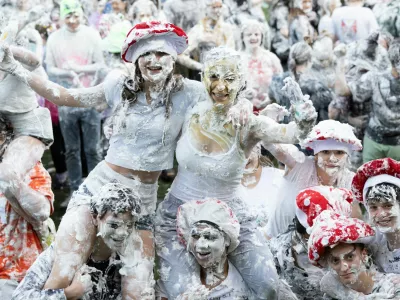 Students from St Andrews University are covered in foam as they leave after taking part in the traditional "Raisin Weekend" in the Lower College Lawn, at St Andrews in Scotland, Britain, October 21, 2024. REUTERS/Lesley Martin