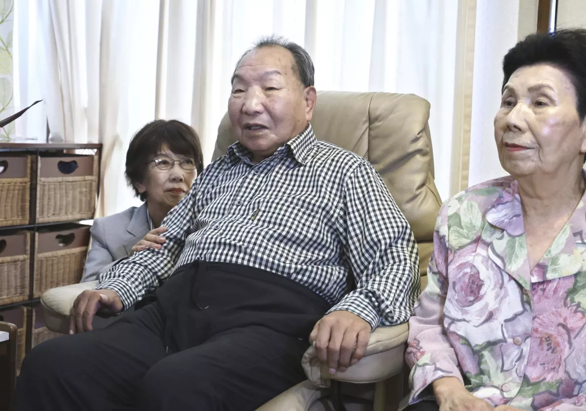 Iwao Hakamada, center, former Japanese death-row inmate acquitted after nearly 50 years on death row, and his sister Hideko, right, receive an apology from Shizuoka Prefectural Police chief Takayoshi Tsuda, not in photo, for his suffering at Hakamada's home in Hamamatsu, Shizuoka prefecture, central Japan, Monday, Oct. 21, 2024. (Kyodo News via AP)