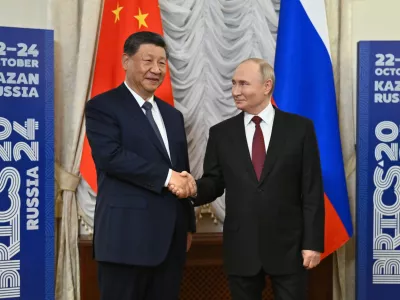 Russian President Vladimir Putin, right, and Chinese President Xi Jinping shake hands during their meeting on the sidelines of BRICS Summit at Kazan Kremlin in Kazan, Russia, Tuesday, Oct. 22, 2024. (Kristina Kormilitsyna/Photo host brics-russia2024.ru via AP)