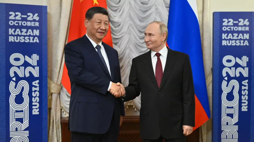 Russian President Vladimir Putin, right, and Chinese President Xi Jinping shake hands during their meeting on the sidelines of BRICS Summit at Kazan Kremlin in Kazan, Russia, Tuesday, Oct. 22, 2024. (Kristina Kormilitsyna/Photo host brics-russia2024.ru via AP)