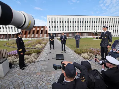 21 October 2024, Mecklenburg-Western Pomerania, Rostock: Boris Pistorius (C), Germany's Defence Minister, speaks to journalists after the installation ceremony for the Commander Task Force Baltic (CTF Baltic) in Rostock, with the Marine Operation Center MOC, headquarters of the new facility, in the background. Photo: Bernd Wüstneck/dpa