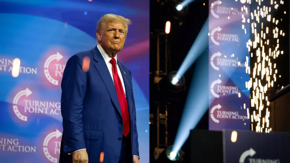 23 October 2024, US, Duluth: ormer US President and Republican presidential candidate Donald Trump is surrounded by sparks from a pyrotechnics display as he greets massive crowd of supporters at Gas South Arena. Photo: Robin Rayne/ZUMA Press Wire/dpa