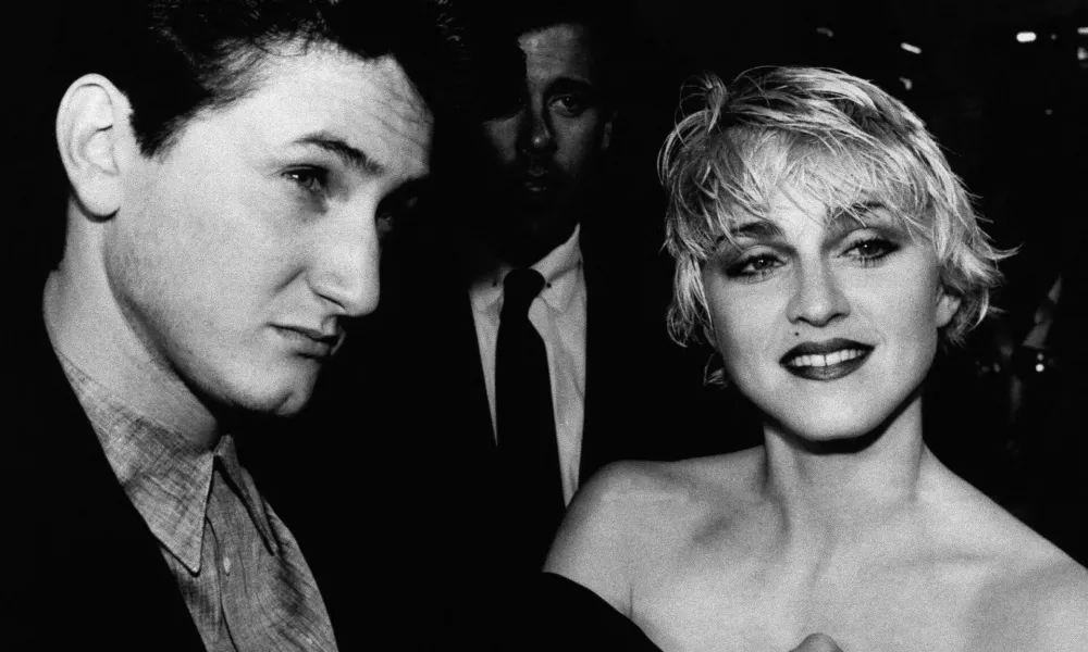 Actor Sean Penn and his wife, singer Madonna, stop to chat with reporters prior to the screening of Penn's new movie "At Close Range" in Los Angeles Thursday night, April 17, 1986. (AP Photo/Craig Mathew)