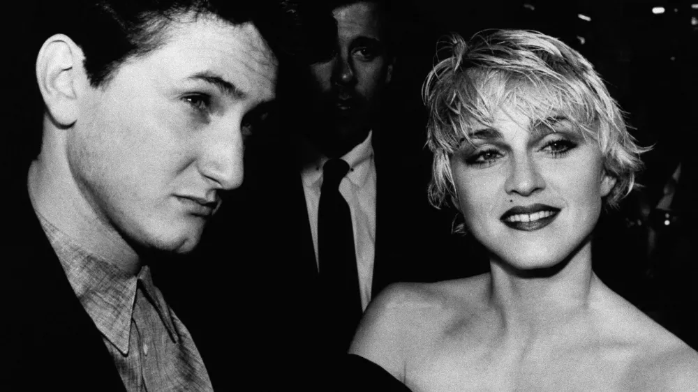 Actor Sean Penn and his wife, singer Madonna, stop to chat with reporters prior to the screening of Penn's new movie "At Close Range" in Los Angeles Thursday night, April 17, 1986. (AP Photo/Craig Mathew)