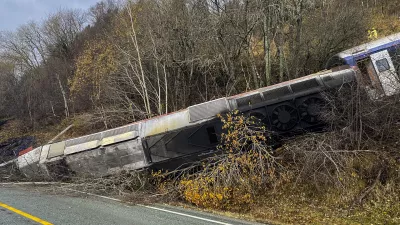 24 October 2024, Norway, Finneidfjord: A derailed train seen between the trees after derailing on the Finneidfjord in Nordland. Photo: Jan Kenneth Transeth/NTB/dpa