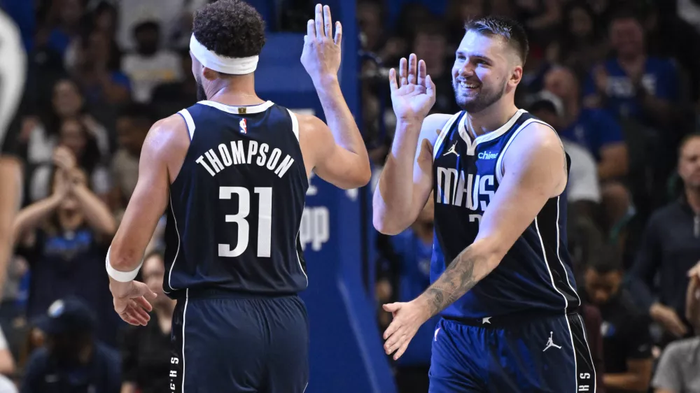 Oct 24, 2024; Dallas, Texas, USA; Dallas Mavericks guard Klay Thompson (31) and guard Luka Doncic (77) celebrate during the second half against the San Antonio Spurs at the American Airlines Center. Mandatory Credit: Jerome Miron-Imagn Images