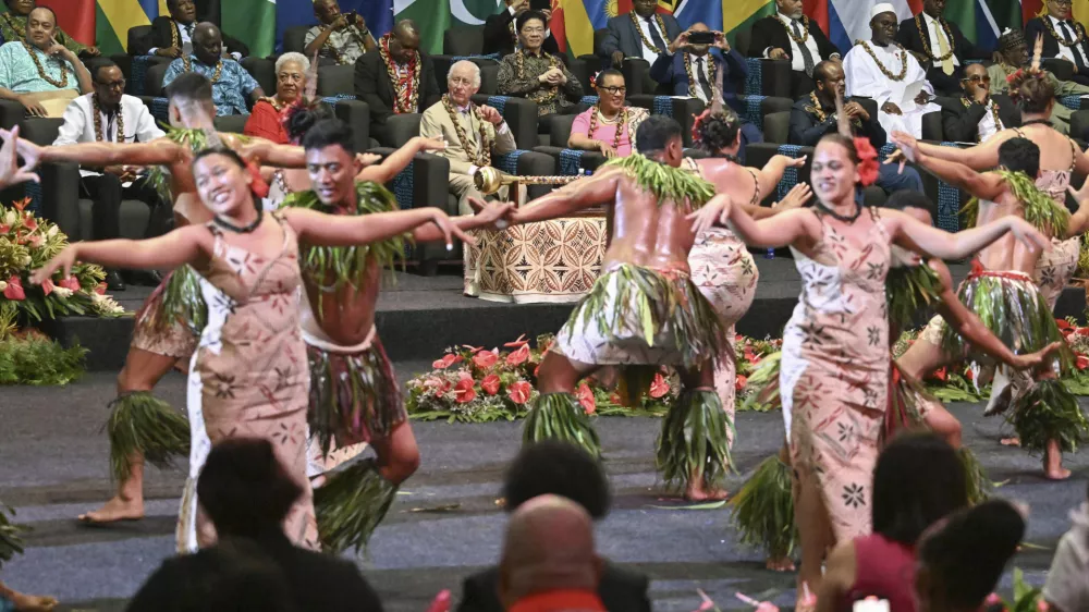 Britain's King Charles III, center, watches as dancers perform during the opening ceremony for the Commonwealth Heads of Government Meeting (CHOGM) in Apia, Samoa, on Friday, Oct. 25, 2024. (AP Photo/William West, Pool)