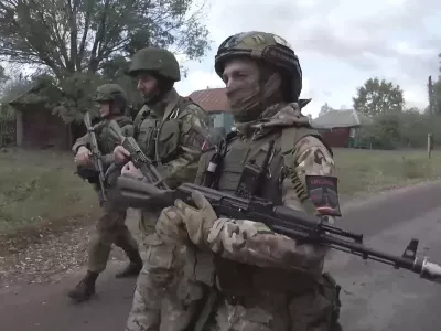 In this photo taken from video released by the Russian Defense Ministry on Thursday, Oct. 24, 2024, Russian soldiers patrol a village in the Russian - Ukrainian border area in ​​the Kursk region, Russia. (Russian Defense Ministry Press Service photo via AP)