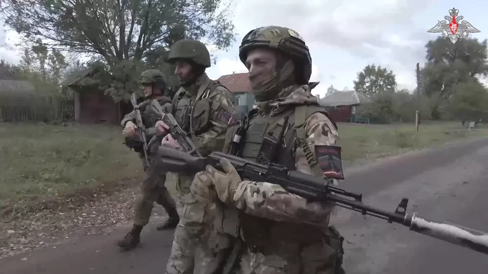 In this photo taken from video released by the Russian Defense Ministry on Thursday, Oct. 24, 2024, Russian soldiers patrol a village in the Russian - Ukrainian border area in ​​the Kursk region, Russia. (Russian Defense Ministry Press Service photo via AP)